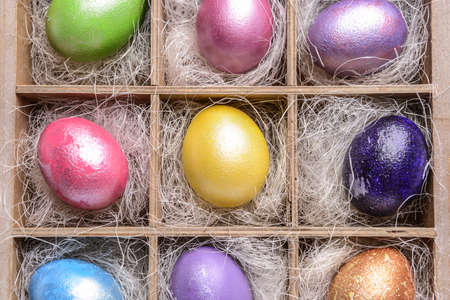 Box with beautiful Easter eggs, top view