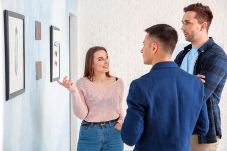 People at exhibition in modern art gallery