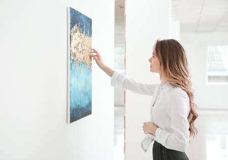 Woman at exhibition in modern art gallery