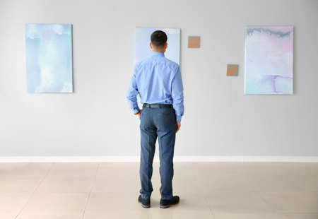 Man at exhibition in modern art gallery