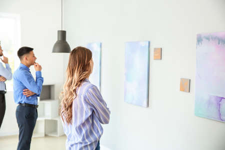People at exhibition in modern art gallery