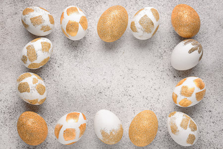 Frame made of beautiful Easter eggs on gray background