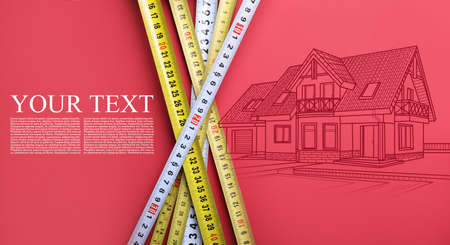 Measuring tapes and building drawing on color background with space for textの写真素材