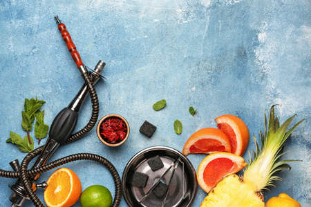 Composition with parts of hookah and fruits on color background