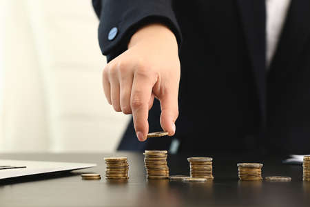 Woman counting savings at table