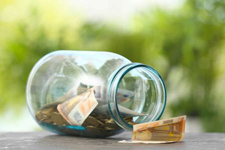 Jar with money on tableの写真素材
