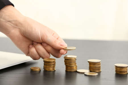 Woman counting savings at table