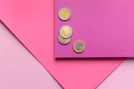 Paper sheets with coins on color background