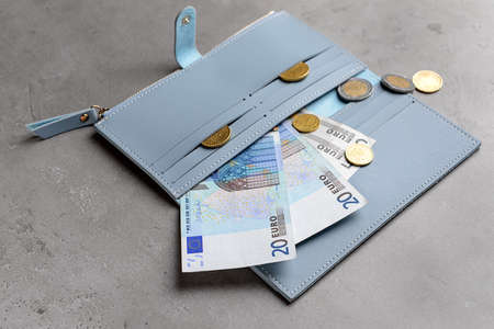 Wallet with money on grunge background