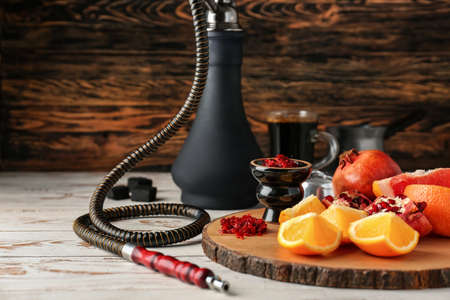 Hookah with tobacco and fresh fruits on tableの素材 [FY310163599008]