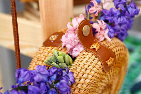 Wicker bag with beautiful hyacinth flowers, closeup