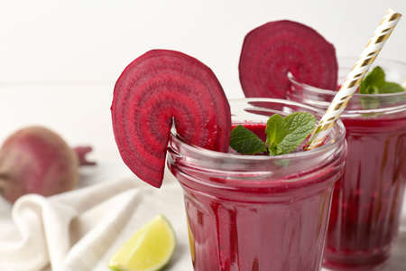 Glasses of fresh beet smoothie on table closeup