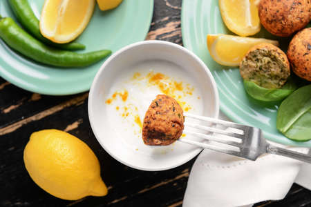 Eating of tasty falafel balls with sauce, closeupの写真素材