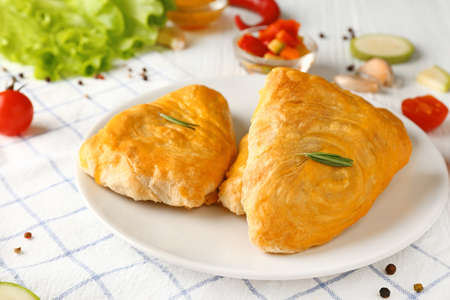 Plate with delicious samosas on table