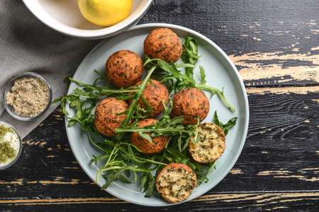 Plate with tasty falafel balls on wooden tableの写真素材