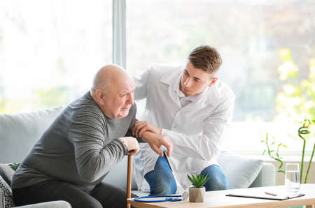 Doctor with senior man in nursing homeの写真素材