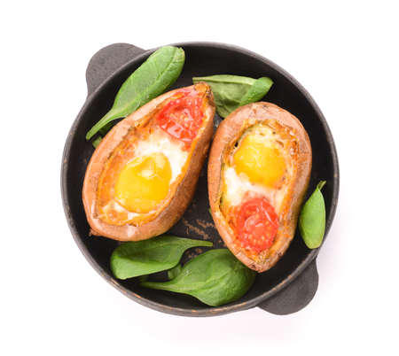 Baked sweet potato with egg and tomato on white backgroundの写真素材