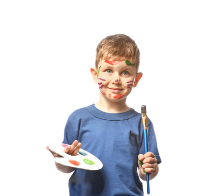 Funny little boy with palette and brush on white backgroundの写真素材