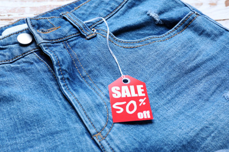 Jeans pants with shopping tag, closeup