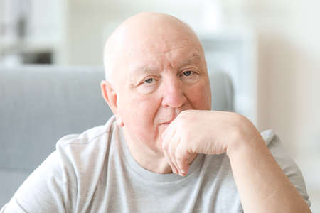 Portrait of sad senior man in nursing home