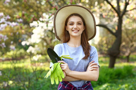 Beautiful female gardener with tools outdoors