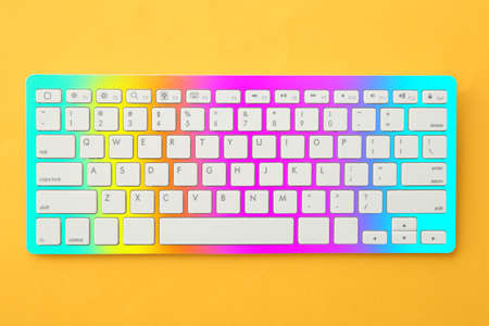 Colorful computer keyboard on yellow backgroundの写真素材