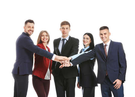 Team of business people putting hands together on white background