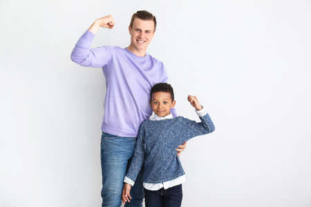 Happy father with little adopted African-American boy at homeの写真素材
