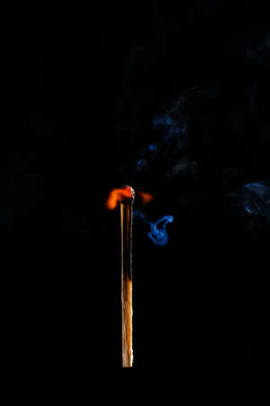 Burning match on dark backgroundの写真素材