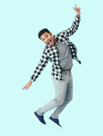 Funny jumping man on color backgroundの写真素材