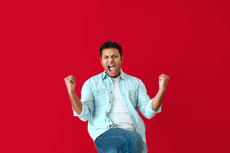 Happy screaming man on color background