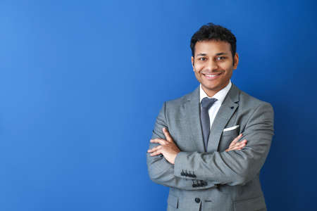 Handsome businessman on color backgroundの写真素材