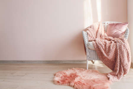 Comfortable armchair near light wallの写真素材