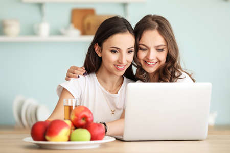 Happy lesbian couple resting at home