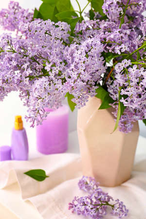Beautiful lilac flowers in vase on table, closeupの写真素材
