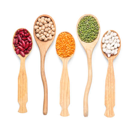 Spoons with different legumes on white backgroundの写真素材