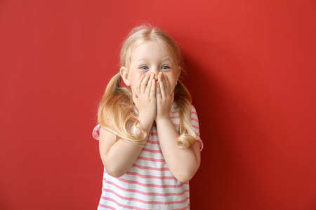 Portrait of adorable little girl on color backgroundの写真素材