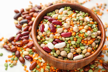 Bowl with different legumes on table