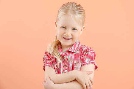 Portrait of adorable little girl on color backgroundの写真素材