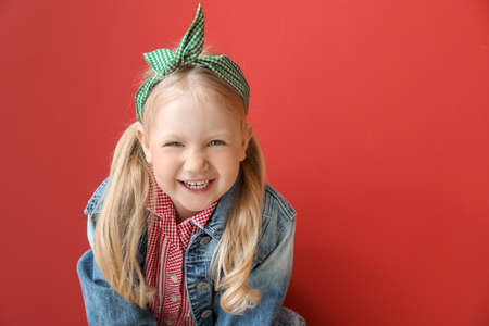 Portrait of stylish little girl on color backgroundの写真素材