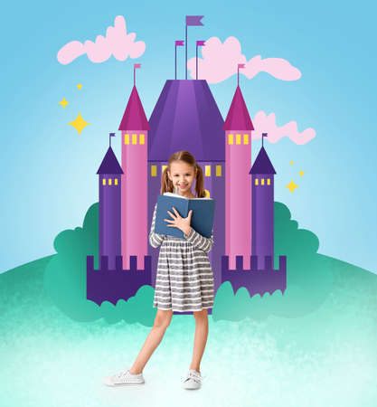 Little girl with magic book near drawn medieval castleの写真素材