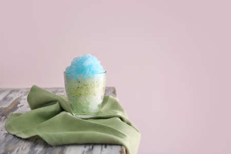 Glass with tasty shaved ice on wooden tableの写真素材