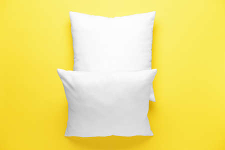 Soft pillows on color background