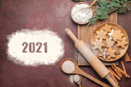 New Year composition with cookies and rolling pin on color backgroundの写真素材