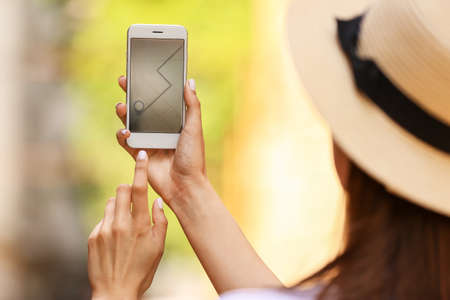 Woman using mobile phone for navigation outdoors