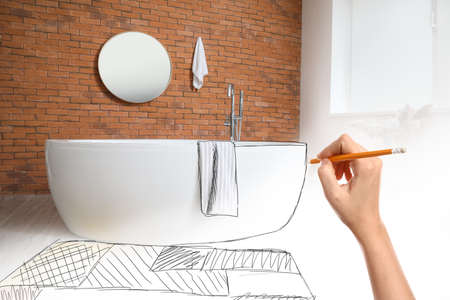 Designer drawing new interior of bathroomの写真素材