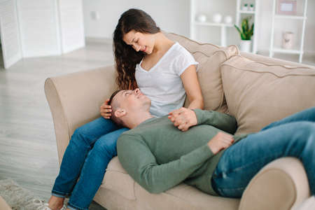 Adorable loving couple resting at home