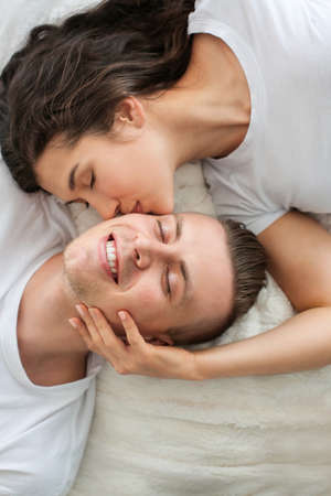 Adorable loving couple lying in bed