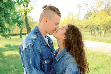 Adorable loving couple resting in park