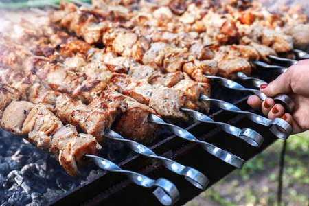 Cooking of tasty shashlick outdoors, closeup
